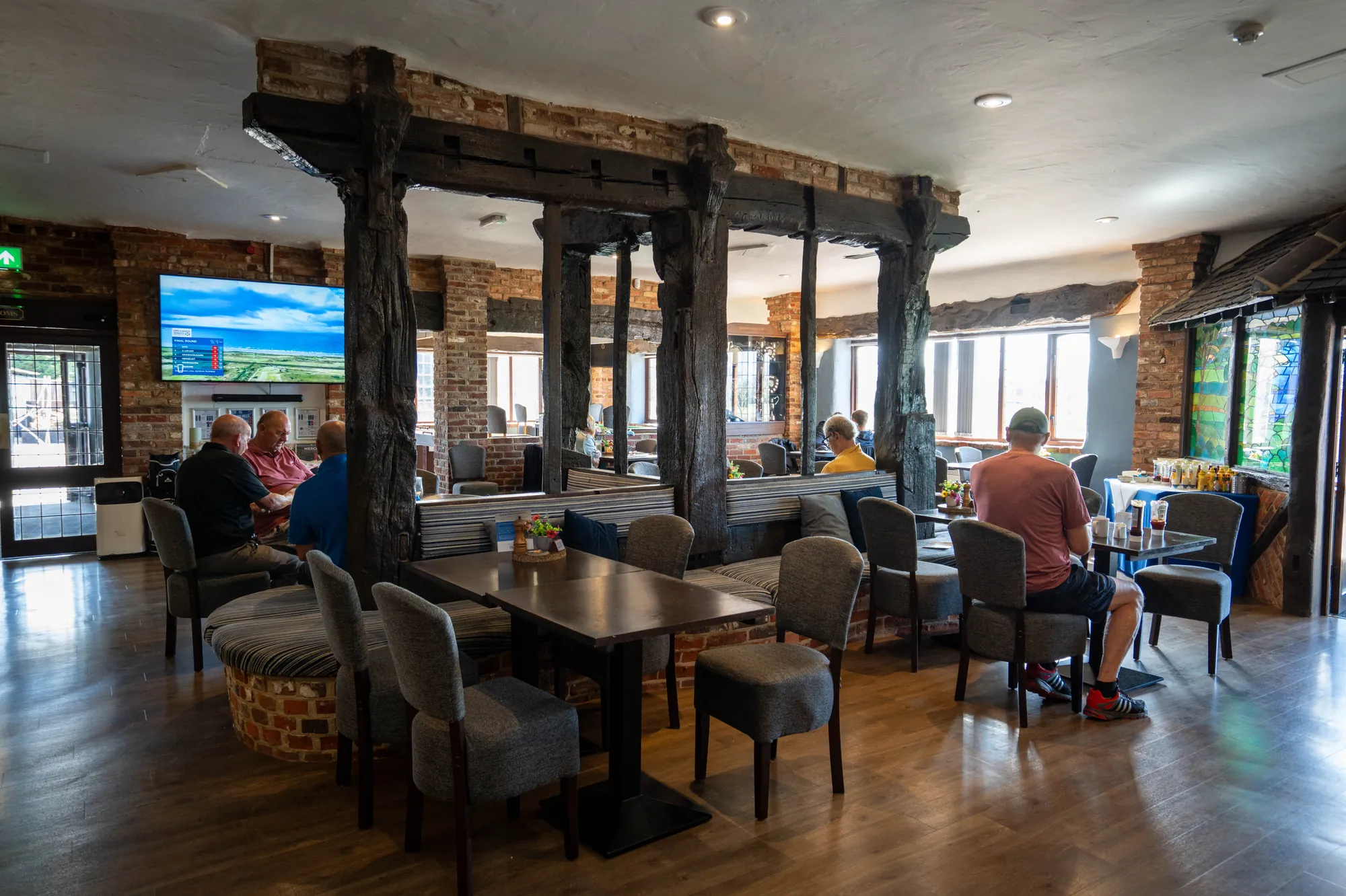 The Elizabethan Restaurant, timber posts and brick walls, golfers at lunch by the windows